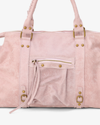 Pink - Pink suede handbag with gold hardware on a light gray background
