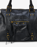 Black - Black leather bag with gold hardware on a white background