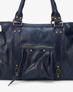 Navy - Blue leather bag with gold hardware on a white background