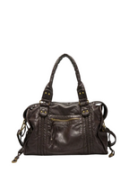 Coffee - leather handbag with decorative straps on a white background